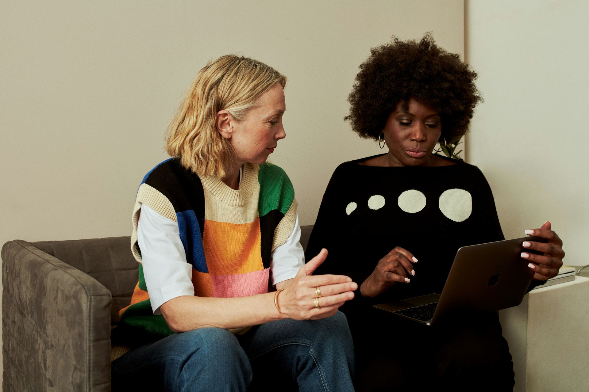 two people sat together with a laptop