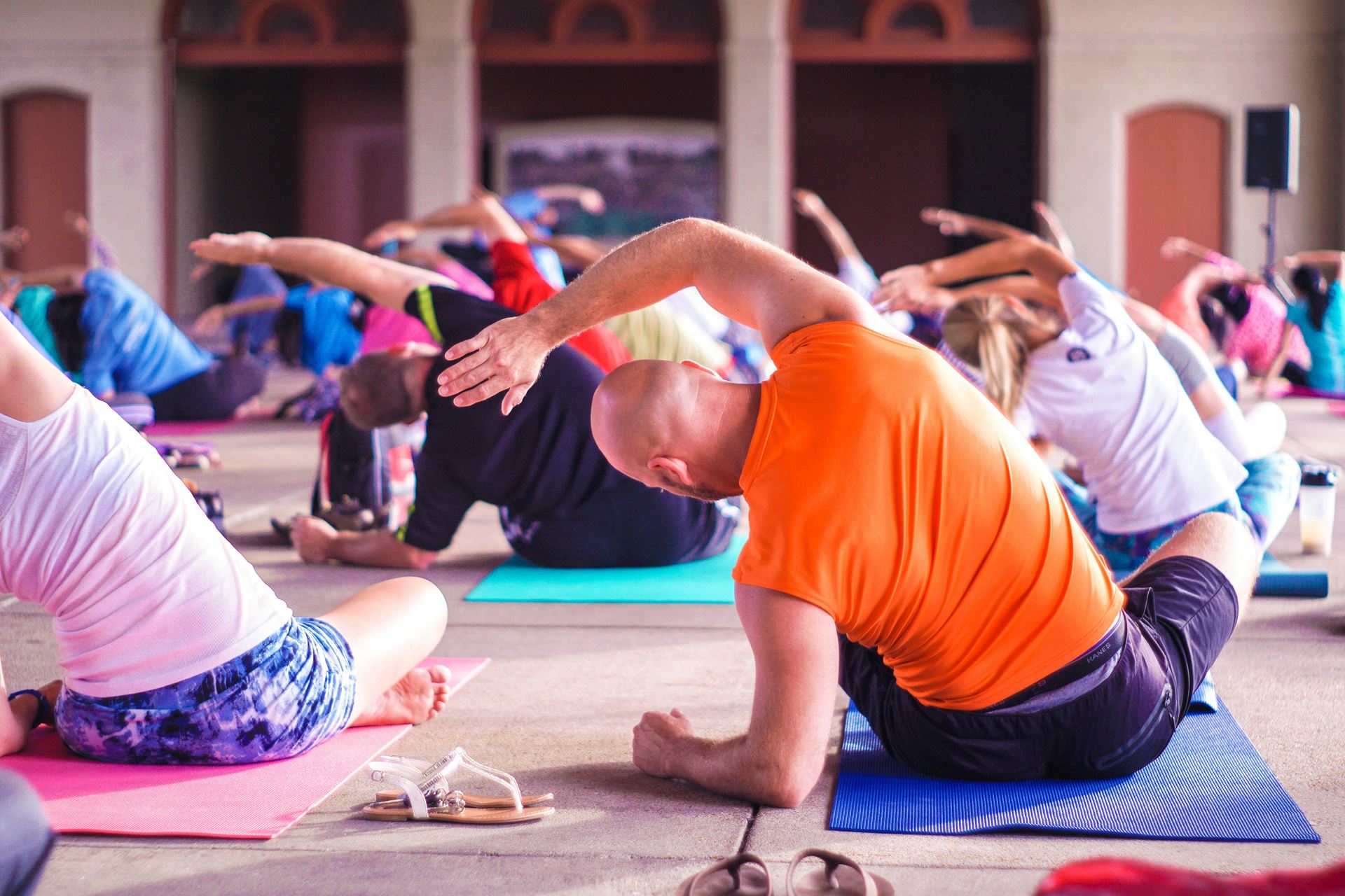 group of men and women doing yoga