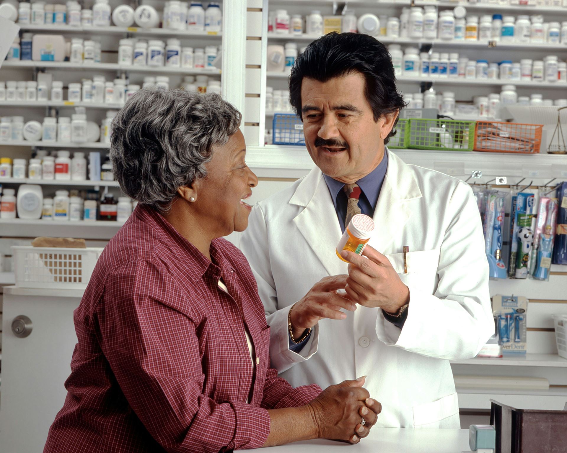 woman with pharmacist collecting her tablets 