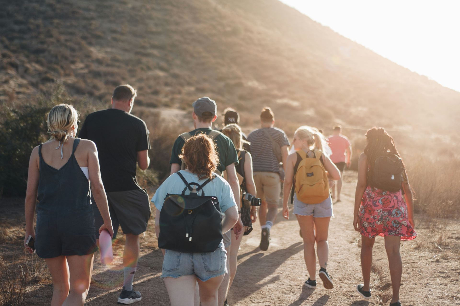 group of people walking in the hills